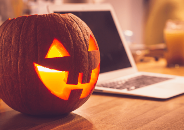 Jack-o-lantern next to a laptop